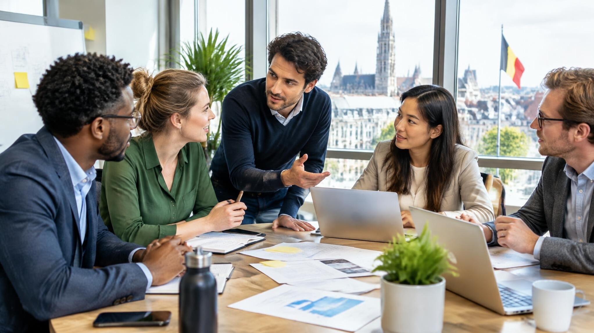Diverse team collaborating around a table with documents